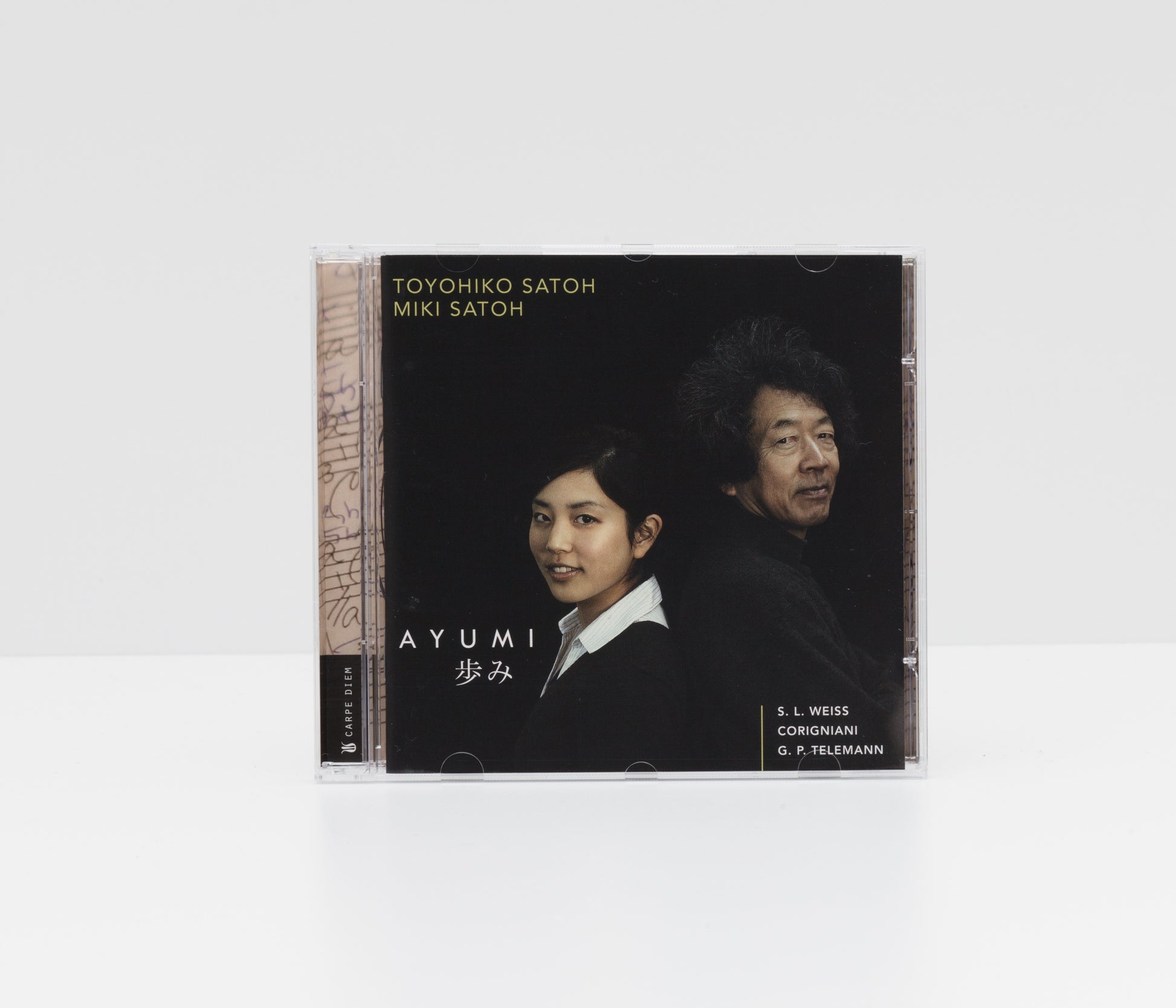 Jewelcase cover of the album "Ayumi" by Toyohiko Satoh and Miki Satoh, showing a portrait of the two artists. 