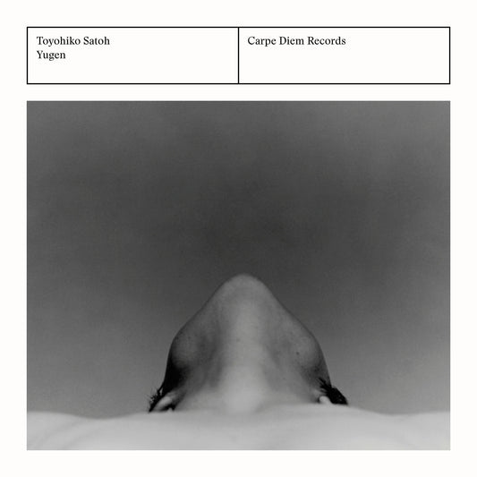 Back cover of the album "Yugen" by Toyohiko Satoh, Walter van Hauwe and Chiyomi Yamada featuring a monochrome portrait of a person from below.