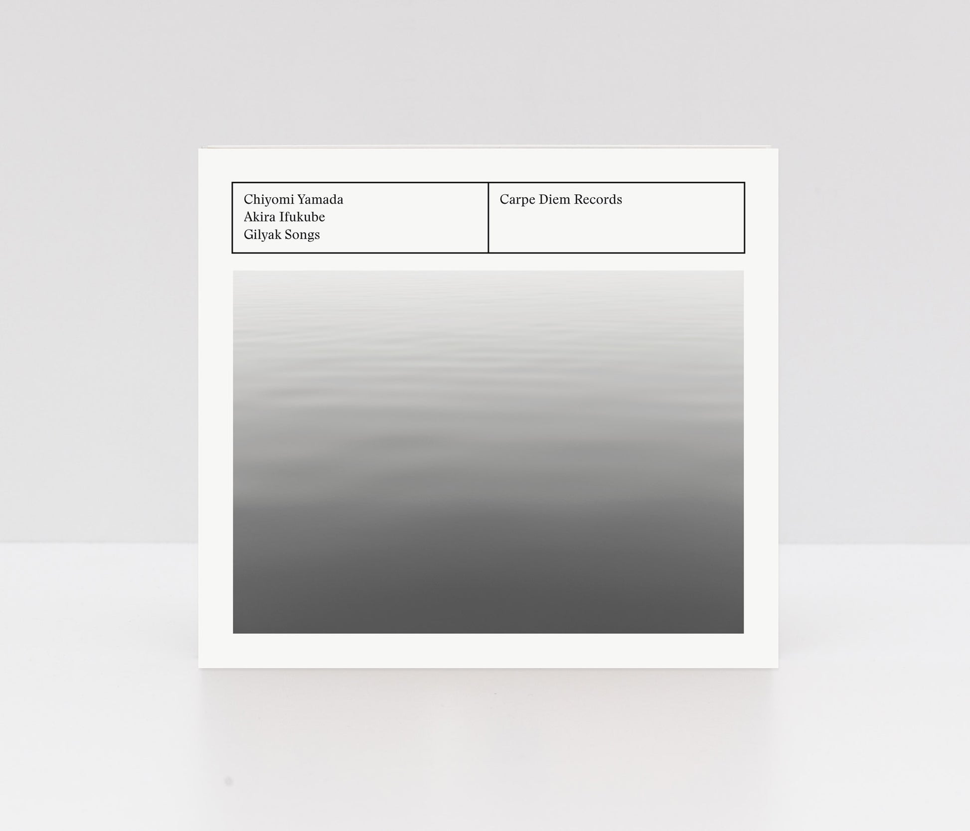 Digipack album cover of "Gilyal Songs" by Chiyomi Yamada, showing a monochrome water surface. 