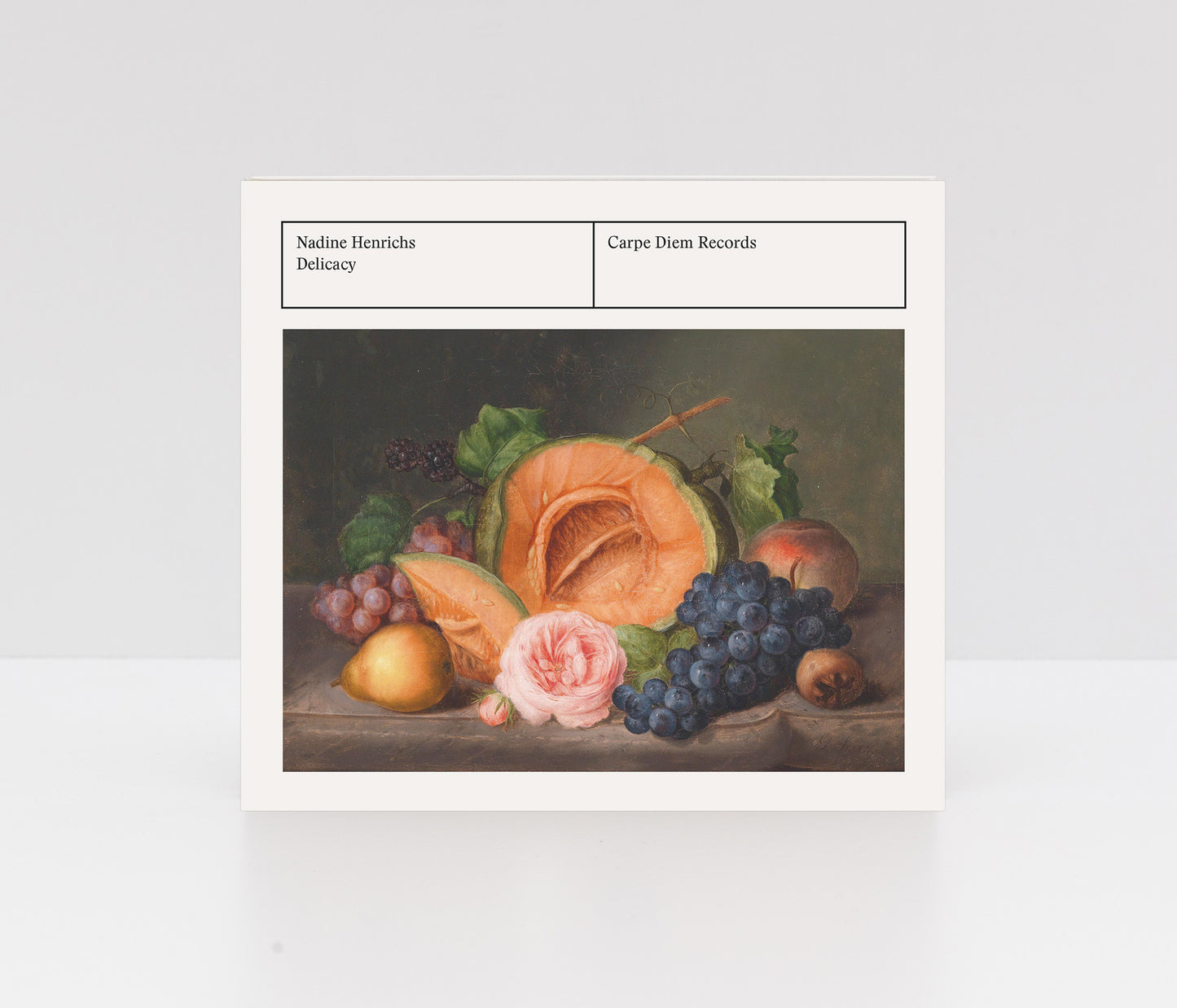 Digipack CD album cover of "Delicacy" by Nadine Henrichs with still life painting of fruits and a flower.