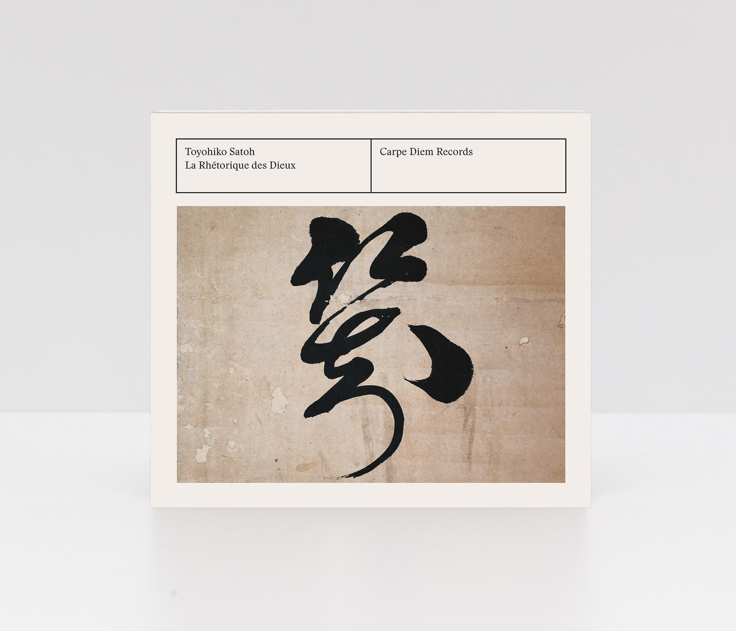 Digipack CD "La Rhetorique des dieux" by Toyohiko Satoh with black Japanese calligraphy on a textured beige background.