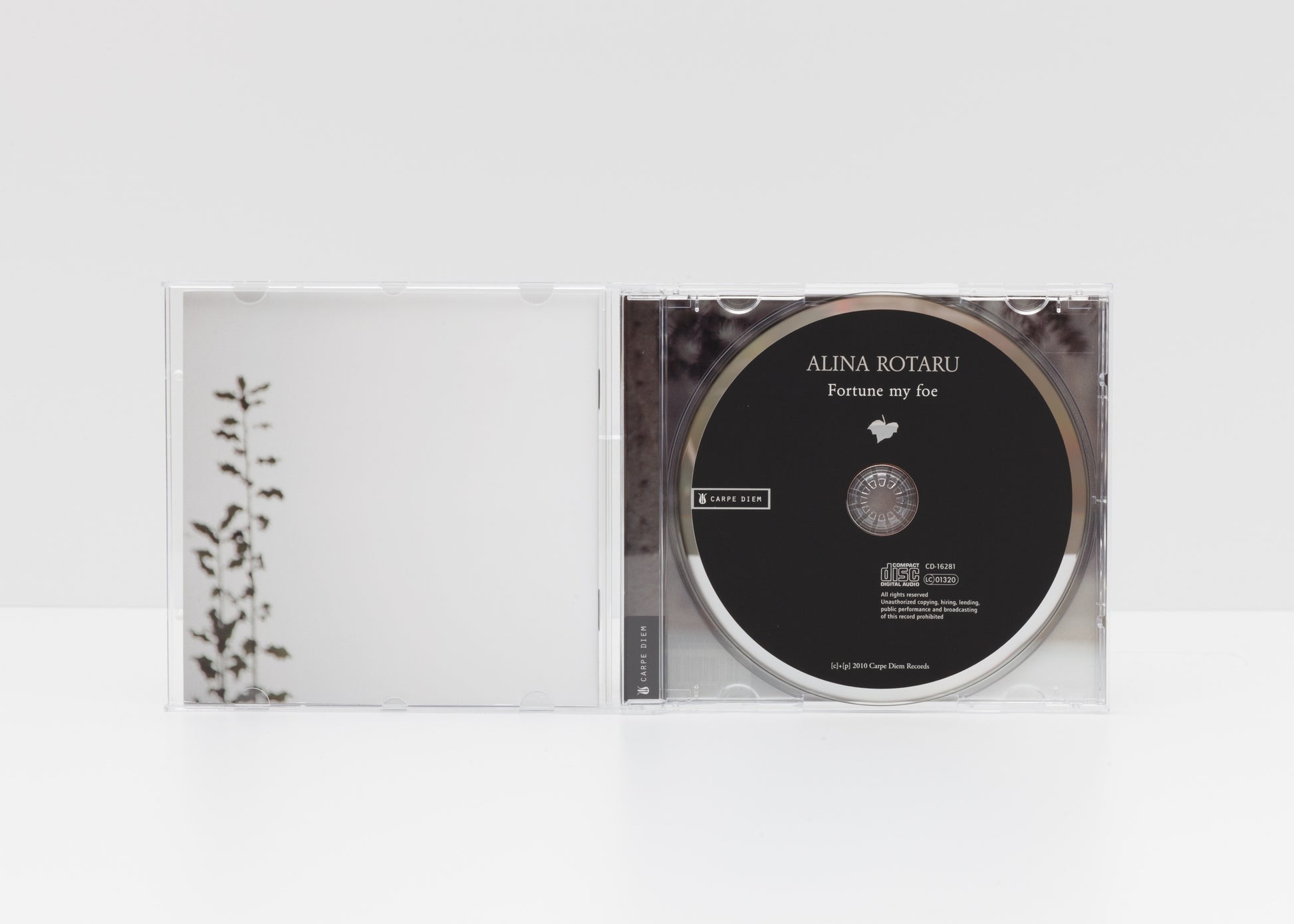 Jewelcase detail of the album "Fortune My Foe" by Alina Rotaru showing some plant leaves and the CD. 