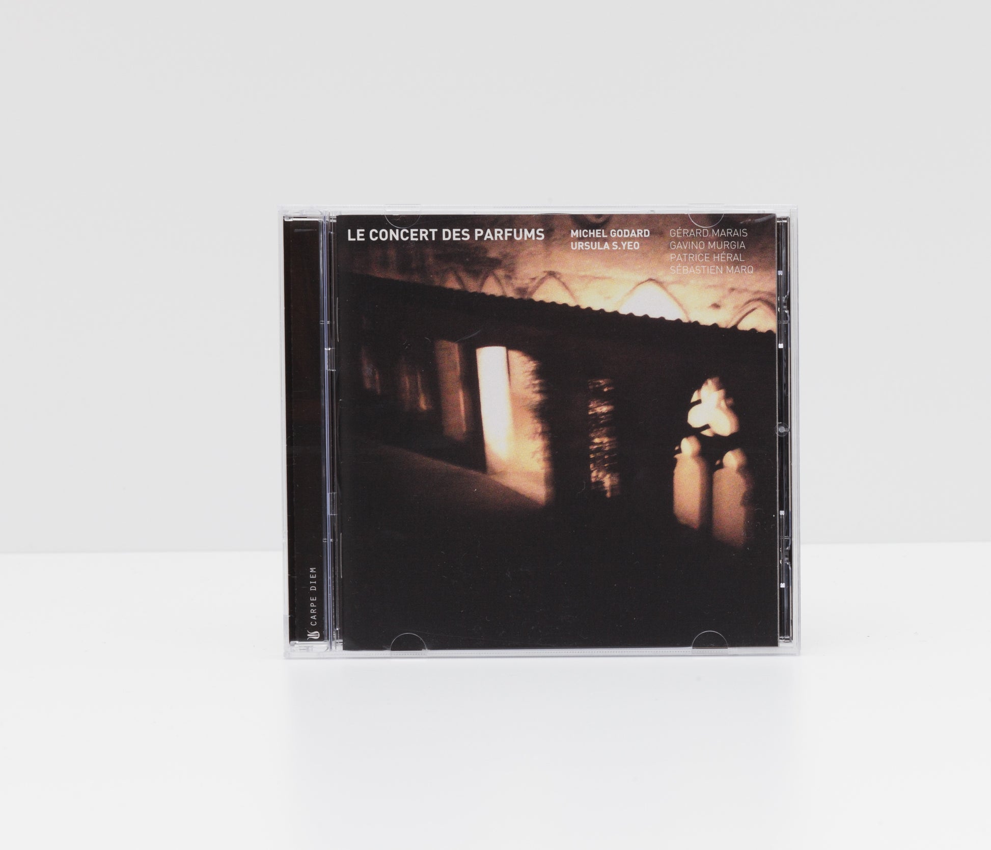 Jewelcase album cover of "Le concert des parfums" by Michel Godard, showing gloomy monastery walls at night. 