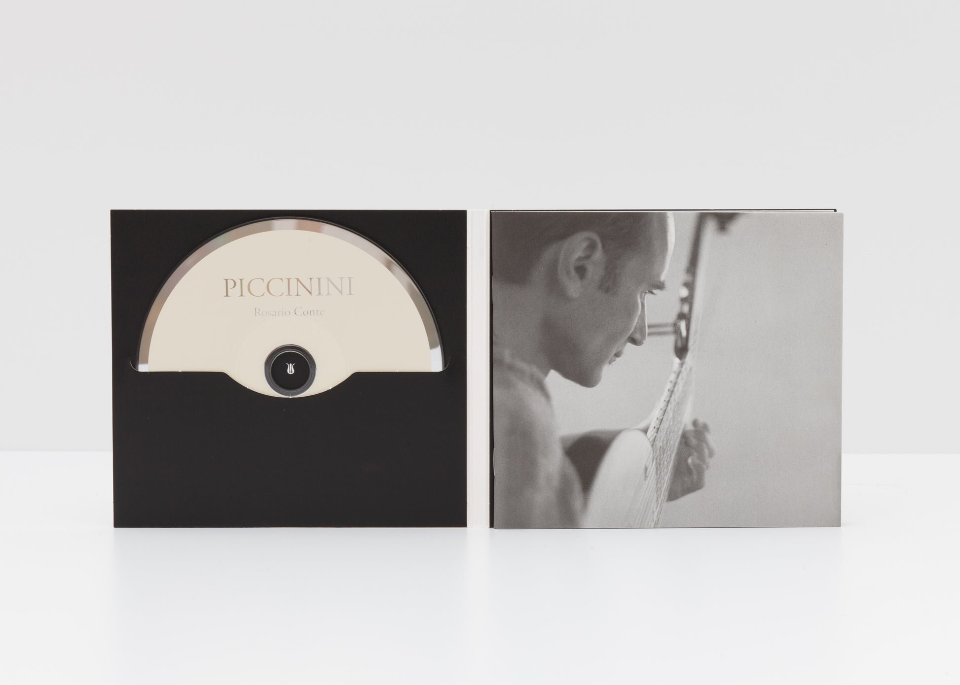 Digipack detail of "Piccinini" by Rosario Conte, showing a photograph of the artist playing an archlute