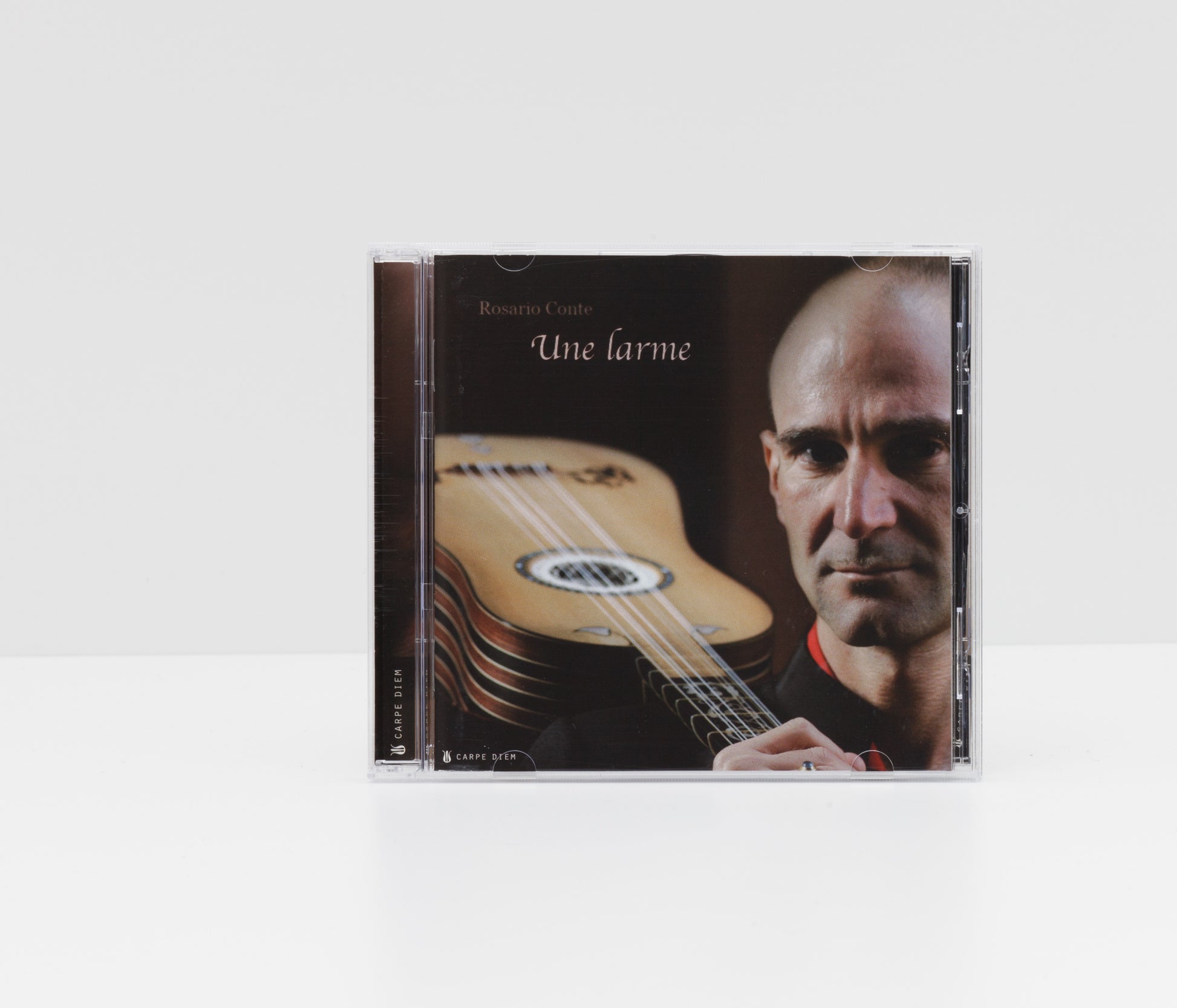 Jewelcase cover of the album "Une Larme" by Rosario Conte, showing the artist holding a baroque guitar