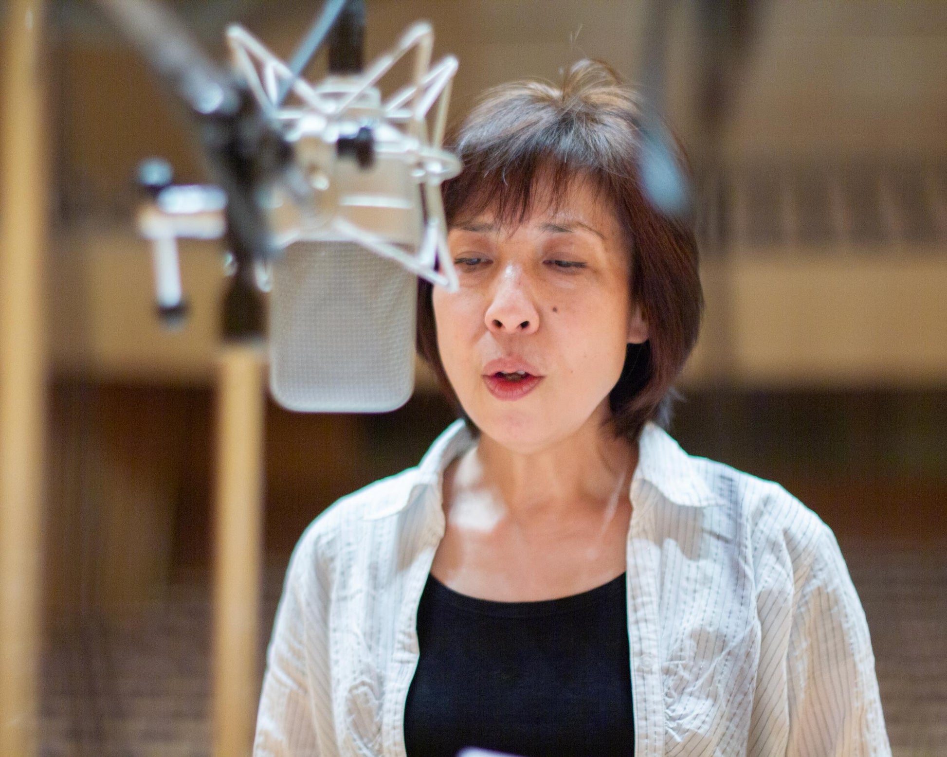 Chiyomi Yamada singing into a microphone at the recording sessions for the album "Yugen" for Carpe Diem Records, in Kirishima, Japan. 